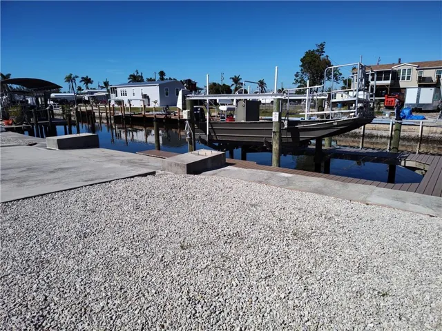 Dock area with boat lift and a water view