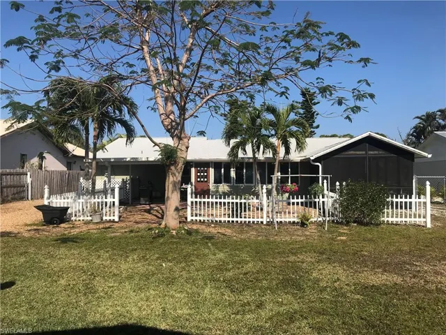 Back of home with picket fence