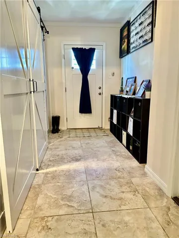 Mud Room.  Entry from Side Yard.  Washer & Dryer behind Barn Doors