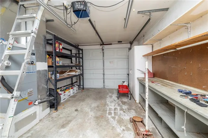 Garage with a workshop area and a garage door opener