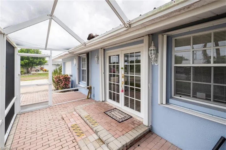 Unfurnished sunroom featuring french doors