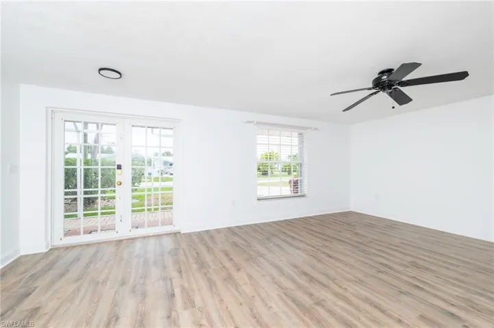 Spare room with french doors, ceiling fan, and light hardwood / wood-style flooring