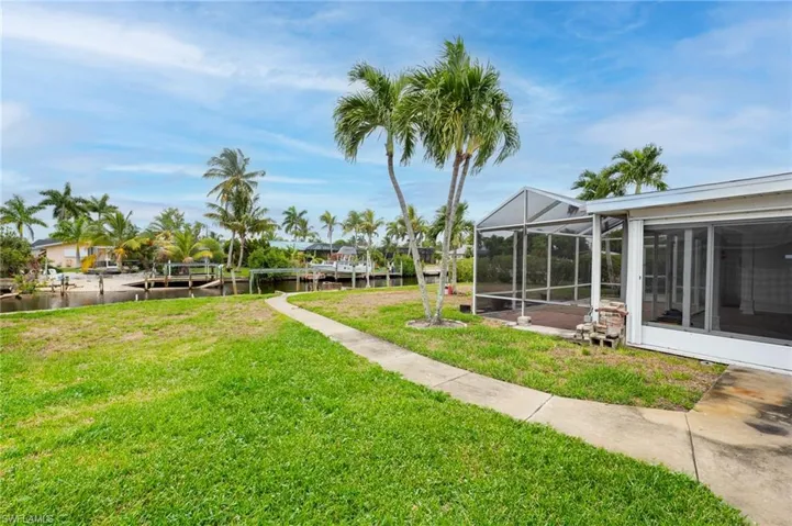View of yard featuring a lanai and a water view