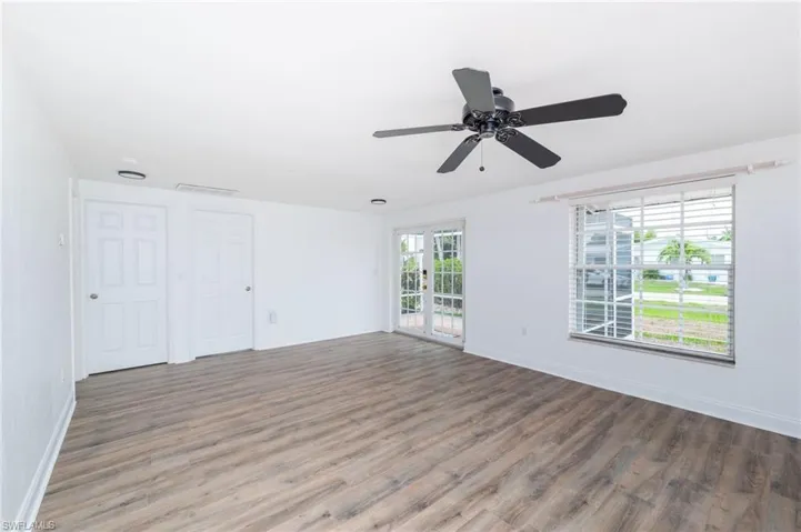Unfurnished room with ceiling fan and hardwood / wood-style flooring