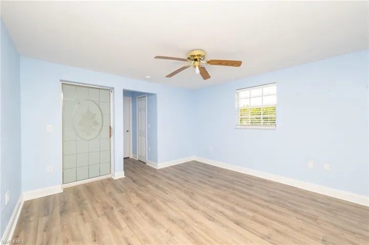 Unfurnished bedroom featuring ceiling fan and hardwood / wood-style flooring