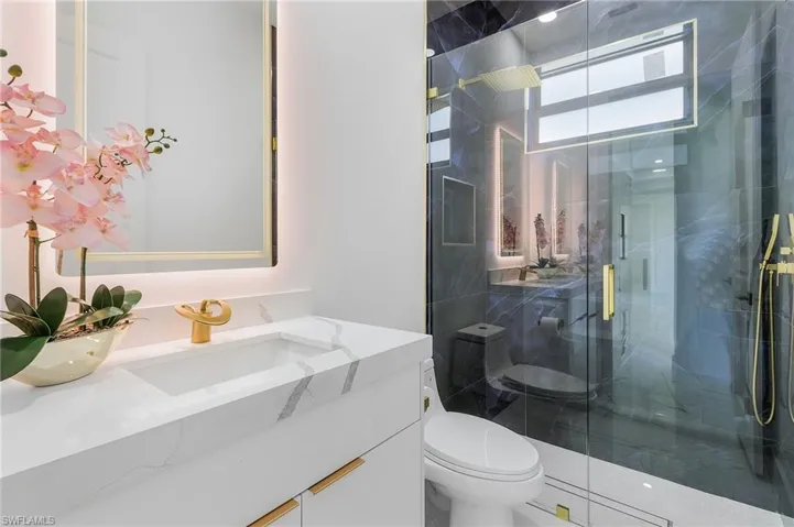 Bathroom with vanity and a stall shower