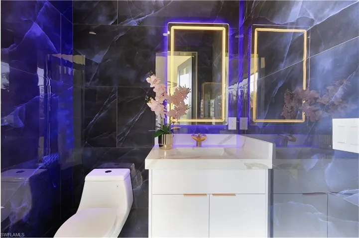 Bathroom with tile walls and vanity