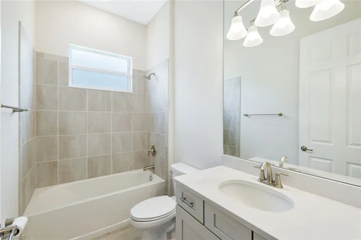 Third full bathroom features a bathtub, single sink and vanity