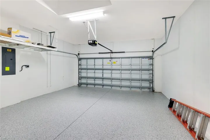 ELECTRIC MORTOR VEHICLE CHARGER INSTALLED IN THE GARAGE. CUSTOM EXPOXY FLOOR