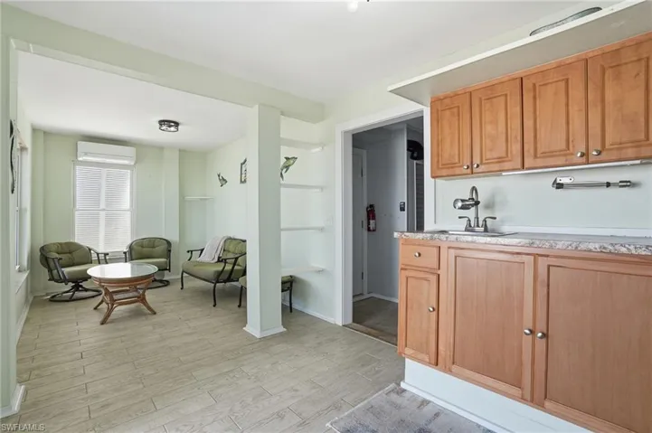 Kitchen featuring light wood-type flooring, a mini split for heating / cooling, and wood finish cabinetry