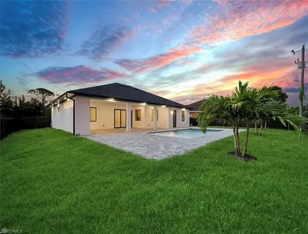 Back of house with a patio, stucco siding, and a fenced backyard