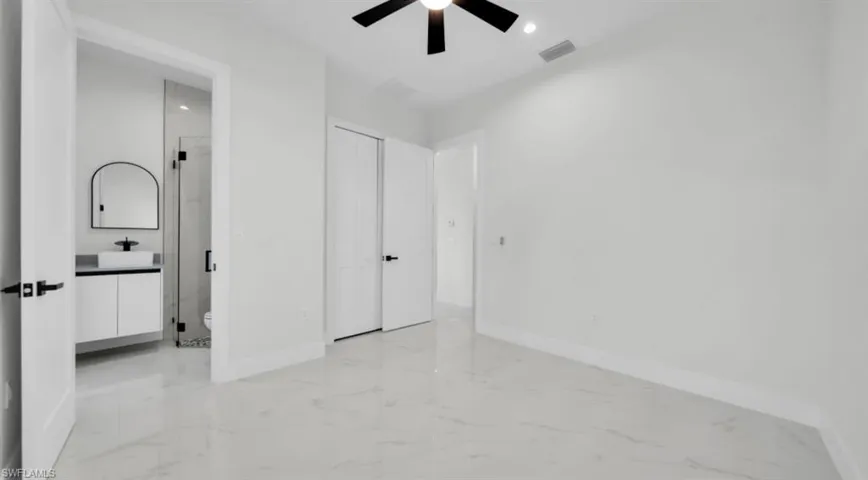 Unfurnished bedroom with light marble finish floors, recessed lighting, and ceiling fan