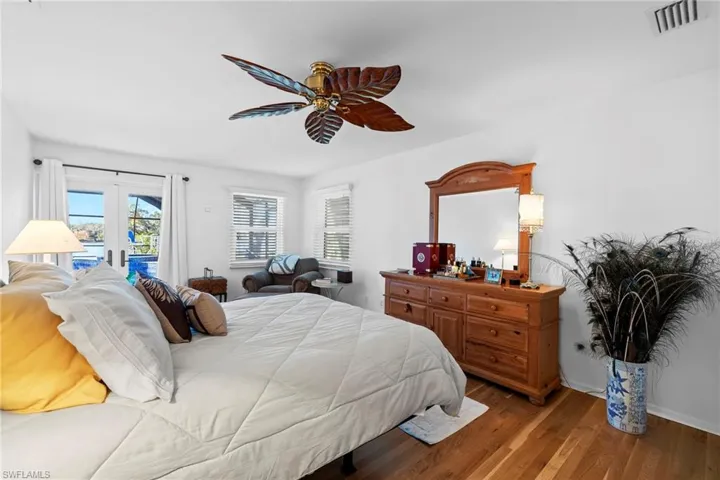Bedroom with access to exterior, hardwood / wood-style floors, french doors, and ceiling fan