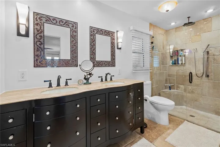Bathroom with walk in shower, vanity, and toilet