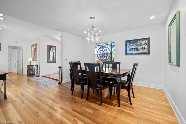 Dining room featuring an inviting chandelier and light hardwood / wood-style floors