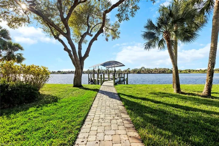 Dock area featuring a water view and a yard