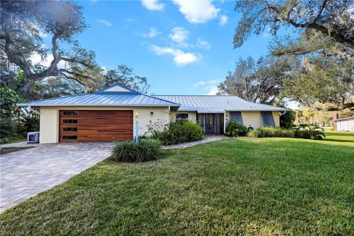 Ranch-style home with a garage and a front yard