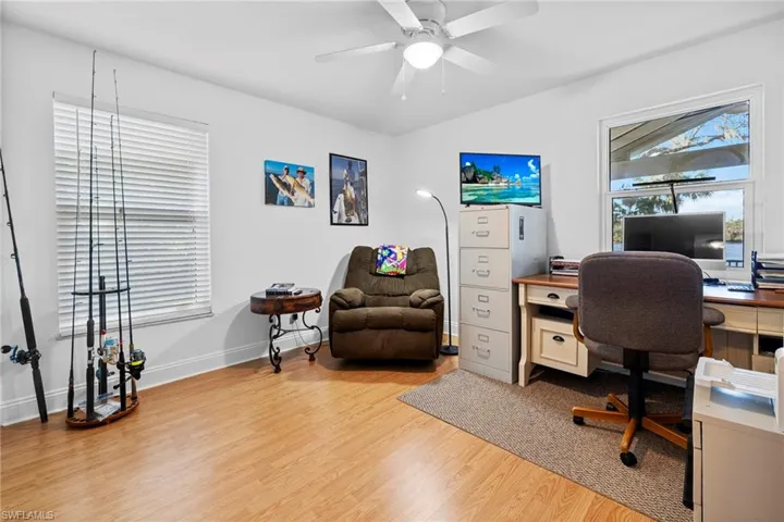 Office space with ceiling fan and light hardwood / wood-style flooring