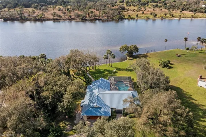 Birds eye view of property with a water view