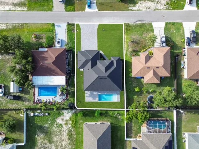 Aerial view of residential area featuring a pool