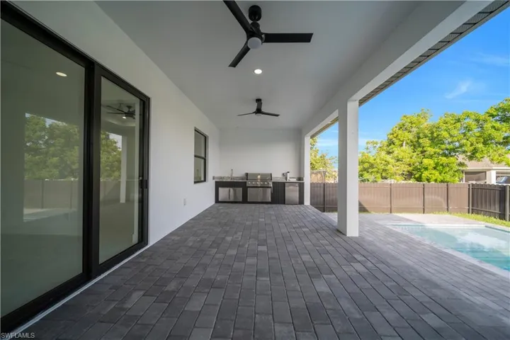 View of patio / terrace with a ceiling fan and a sink