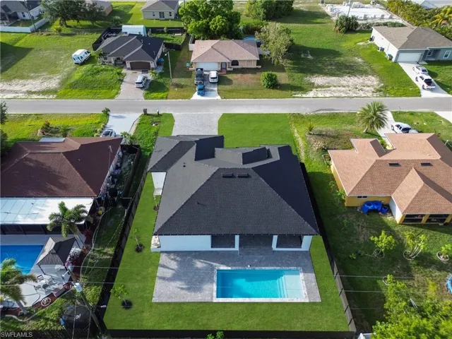 Aerial perspective of suburban area featuring a pool