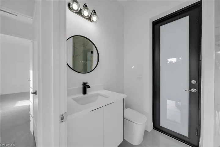 Full bath with vanity, toilet, and a shower