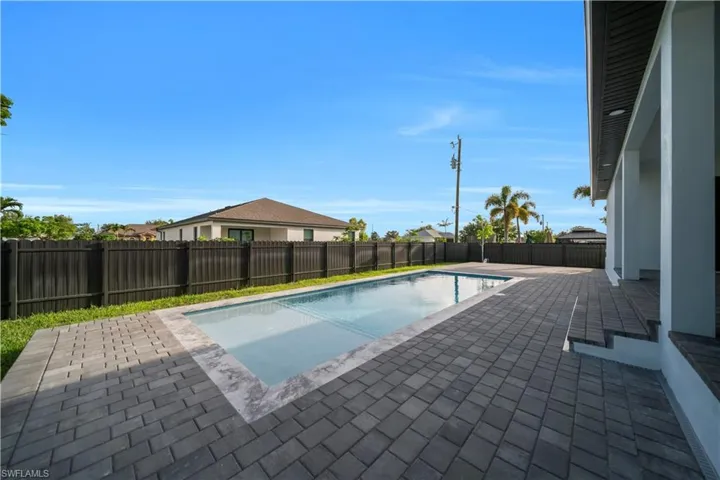 View of pool featuring a patio and a fenced backyard