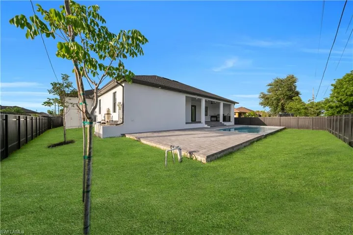 Back of house with stucco siding and a patio area