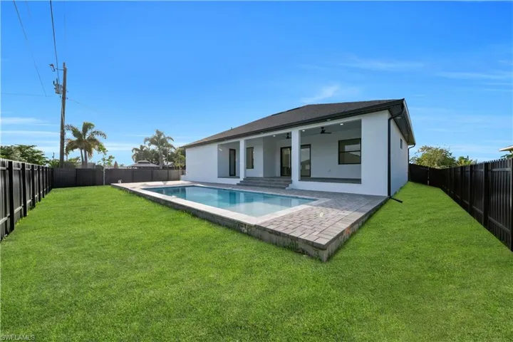 Rear view of property with a ceiling fan, a patio area, and stucco siding