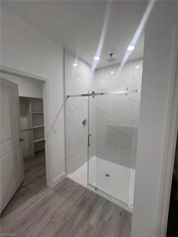 Bathroom with wood-type flooring and walk in shower