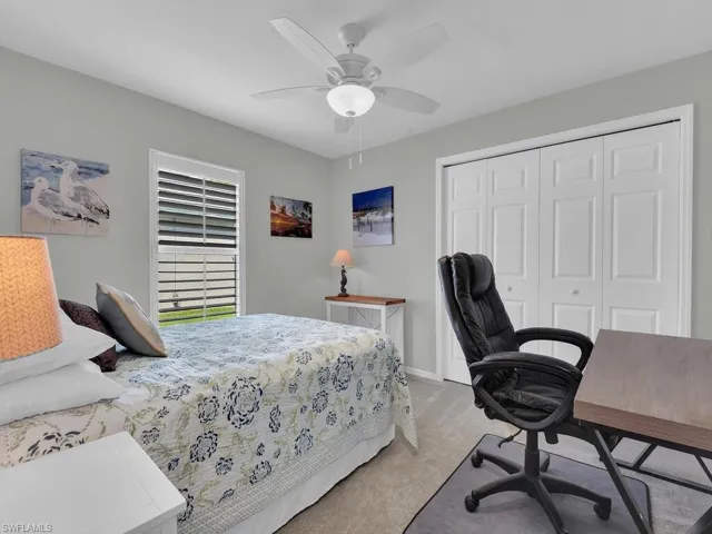 Guest room with queen size bed, desk and closet with built-in shelves