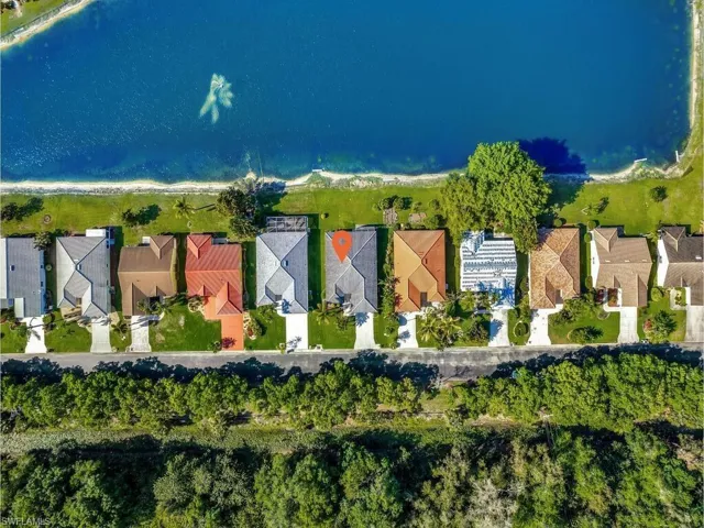 View of home with lake and preserve views
