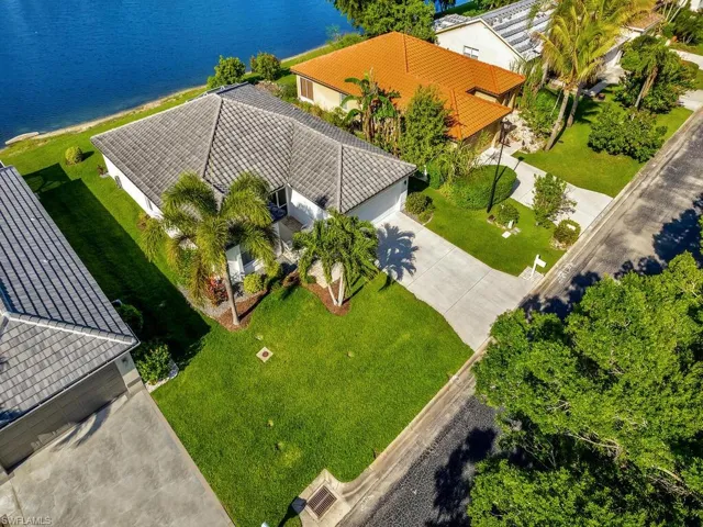 View of home with landscaping and preserve across the street