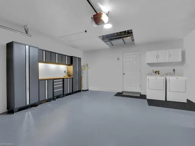 Large 2-car garage with washer/dryer, laundry cabinets and painted floor
