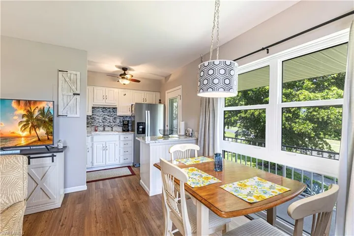 Dining area with dark hardwood / wood-style flooring, ceiling fan, and sink