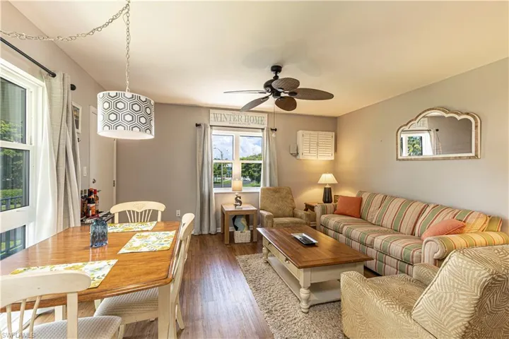 Living room featuring wood-type flooring and ceiling fan