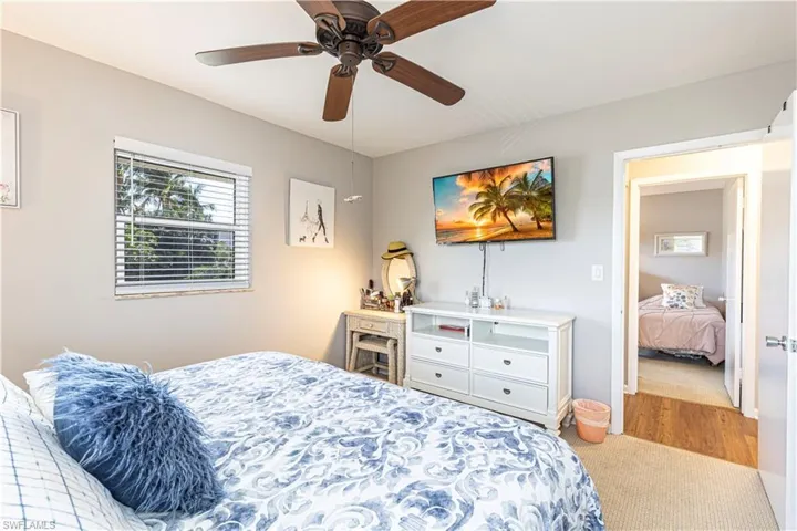 Bedroom with light hardwood / wood-style flooring and ceiling fan