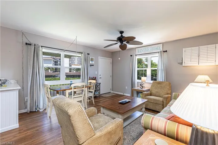 Living room featuring wood-type flooring and ceiling fan