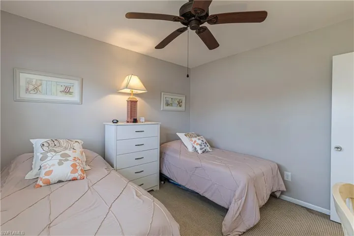 Carpeted bedroom with ceiling fan
