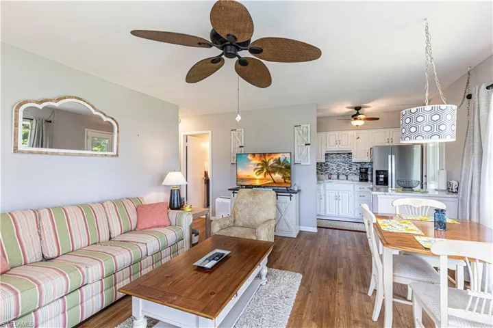 Living room featuring ceiling fan and dark hardwood / wood-style flooring