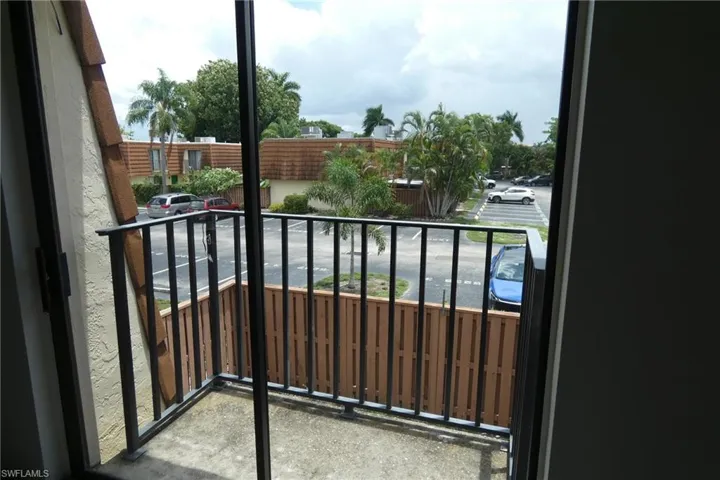 Private balcony featuring a concrete floor and black metal railing