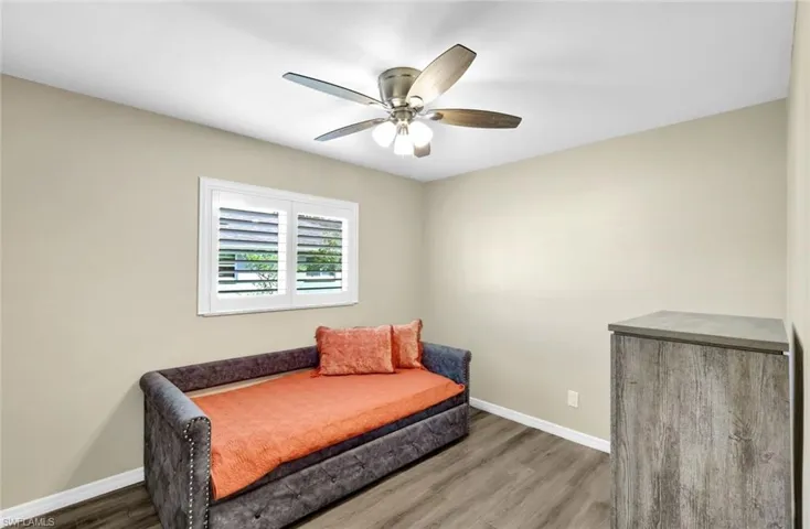 Living area featuring dark hardwood / wood-style floors and ceiling fan
