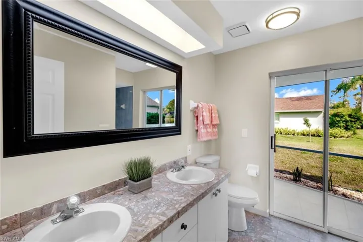 Bathroom featuring tile patterned floors, vanity, and toilet