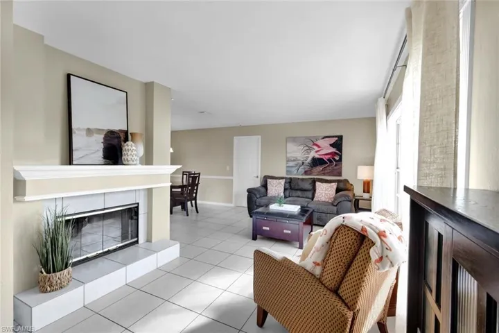 Living room featuring light tile patterned flooring and a tiled fireplace