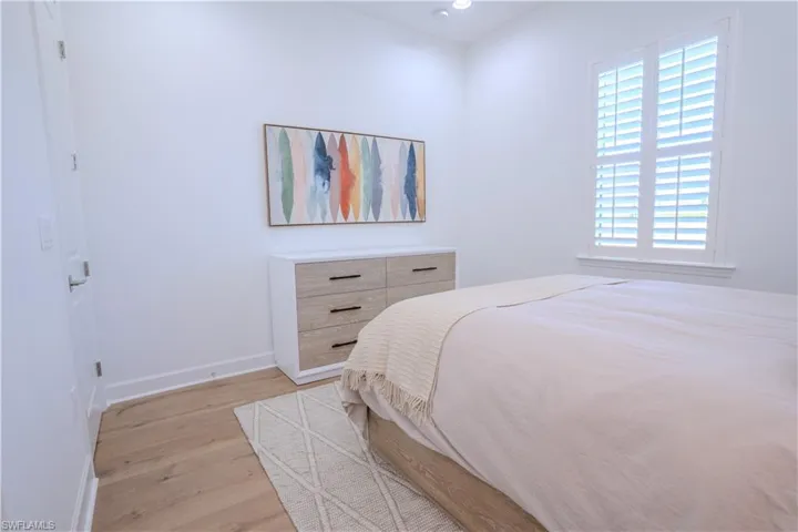 Bedroom with light hardwood / wood-style flooring