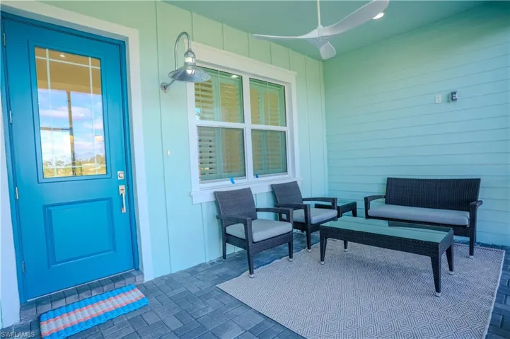 Entrance to property featuring a patio and ceiling fan