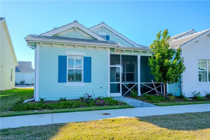 View of front of home featuring a sunroom and a front yard