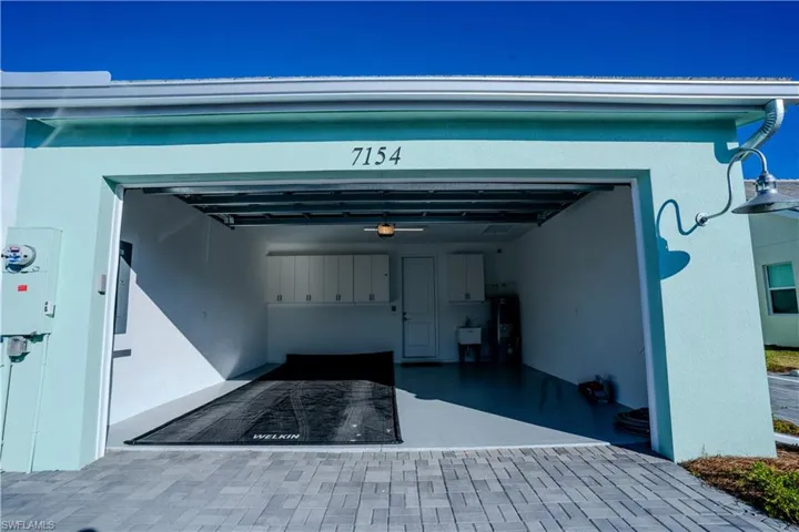 Garage with a garage door opener and electric water heater