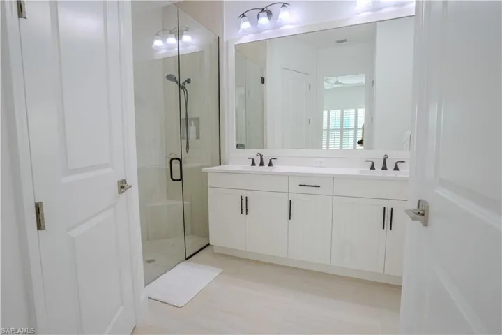 Bathroom featuring vanity and an enclosed shower